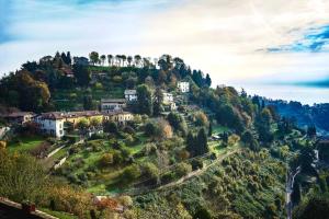 a house on top of a hill with trees at ChicLife - LILIENBLUM CHIC Borgo Santa Caterina Apartment in Bergamo