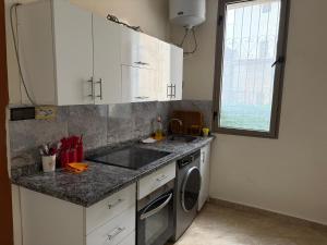 a kitchen with a sink and a washing machine at Neoclassical apartment downtown in Casablanca +6 photos