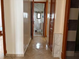 a hallway leading to a bathroom with a mirror and a hallwayngthngthngthngth at Neoclassical apartment downtown in Casablanca