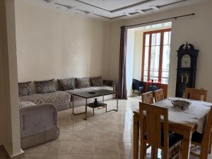 a living room with a couch and a table at Neoclassical apartment downtown in Casablanca