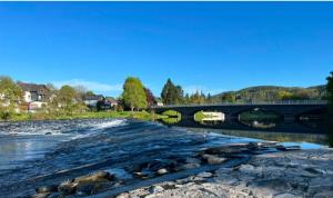 a river with a bridge in the background at Ferienwohnung Doria in Windeck