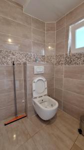 a bathroom with a toilet in a room at Coco 2 free parking in Pržno