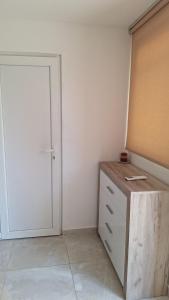 a room with a closet with a door and a dresser at Coco 2 free parking in Pržno