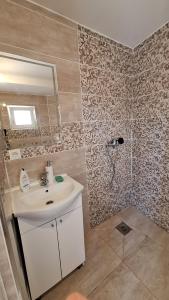 a bathroom with a sink and a shower at Coco 2 free parking in Pržno