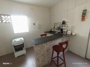 a small kitchen with a counter and a stove at kit Net no Vinhais in São Luís