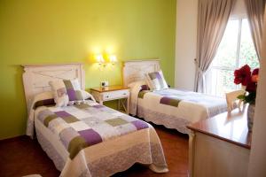 Posteľ alebo postele v izbe v ubytovaní Hostal Los Pinos