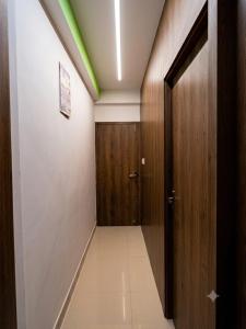 a hallway with a wooden door and a hallway sidx sidx at Elora Hotel in Ujjain