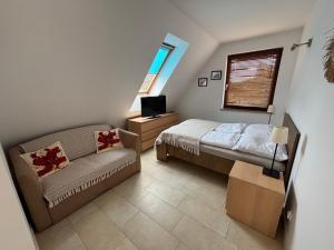 a small bedroom with a bed and a couch at Bursztynowa 16 Hel in Hel +60 photos