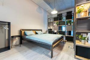 a bedroom with a bed and a book shelf at Industrial Apartment ZERO in Bratislava