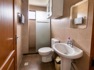 a small bathroom with a toilet and a sink at Hipódromo Sky Penthouse in Cochabamba
