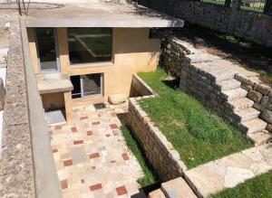 an aerial view of a house with a stone wall at Dar el Maasser دار المعاصر in Maasser El Chouf