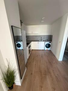 an empty kitchen with a sink and a refrigerator at Milk Market Inn in Limerick
