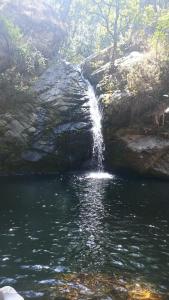 a waterfall on the side of a river at Dhankeshwar Dham Homestay in Champawat