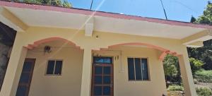 a house with a spider on the front of it at Dhankeshwar Dham Homestay in Champawat