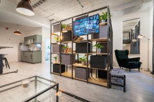 a living room with a large bookcase with a tv at Industrial Apartment ZERO in Bratislava
