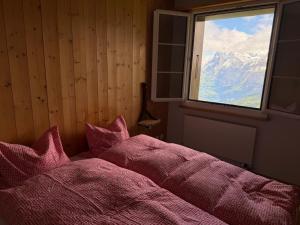 a bedroom with a bed with a view of a mountain at Stöcki-Grindelwaldblick in Kleine Scheidegg