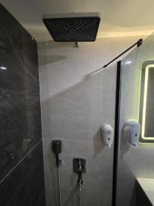 a bathroom with a shower with a light on the wall at Real Hotel Van in Ipekyolu