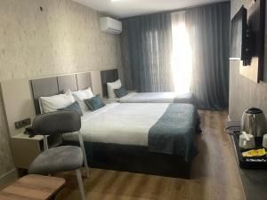a bedroom with a large bed and a window at Real Hotel Van in Ipekyolu