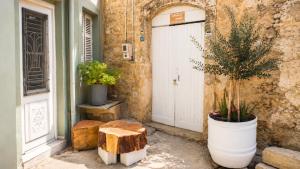 a entrance to a building with a door and plants at Lemoni's House in Krousón +7 photos
