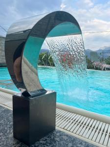 a sculpture in front of a pool of water at Villa Nogara in Menaggio