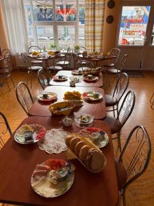 a group of tables with plates of food on them at Arkadia - Amber in Jantar