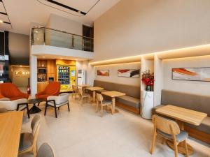 a restaurant with tables and chairs in a room at Hotel 7 Days Duc Hoa in Ấp Bình Tả (2)