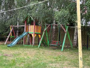 a playground with a slide in a yard at Arkadia - Amber in Jantar