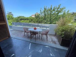 a patio with a table and chairs on a balcony at Villa Julie in Biarritz +3 photos