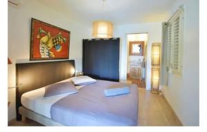 a bedroom with a large bed with two pillows at MangOdiamant, la vue sur mer, la plage à pied in Le Diamant