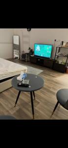 a living room with a coffee table and a tv at Ksa2 in Hail