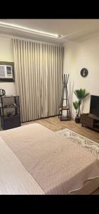 a bedroom with a large white bed and a window at Ksa2 in Hail