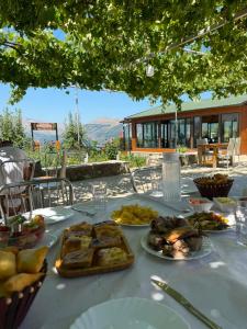 a table with plates of food on top of it at Vatra Traditional Guesthouse in Lekdush