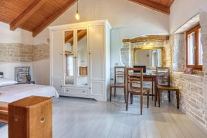 a bedroom with a bed and a table and chairs at Holiday House Ante in Žminj