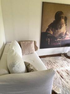a living room with a couch and a painting on the wall at Buhne 27 in Dierhagen +42 photos