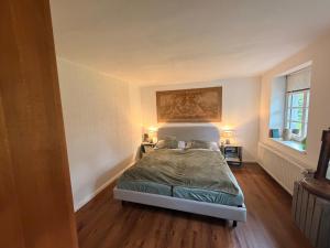a bedroom with a bed and two lamps in it at Buhne 27 in Dierhagen