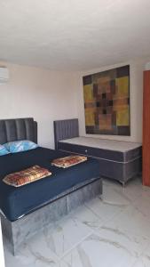 a bedroom with two beds and a painting on the wall at Diamond by EXCLUSIVE Collection Sea view apartments in Dobra Voda