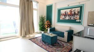 a living room with a couch and a table at Sofitel Caravanserai 1BHK Noida, Spectrum Mall Sector 75 in Noida