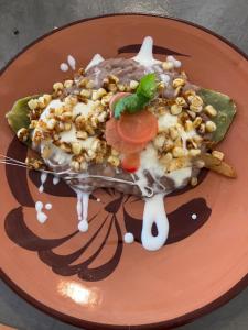 a plate with a dessert with nuts on it at La Sagrada in Guanajuato