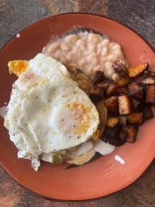 a plate of food with eggs and gravy and potatoes at La Sagrada in Guanajuato +18 photos
