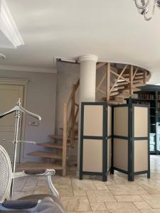 a room with a treadmill and a spiral staircase at Willa Oliwa in Gdańsk