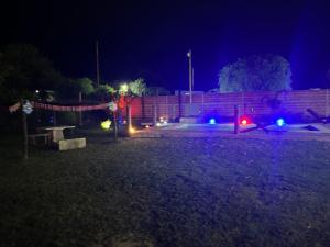 a yard at night with lights and a fence at El triángulo finca familiar in Maco