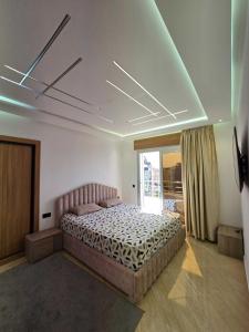a bedroom with a bed in a room with a window at panoramic sky 17 in Tangier