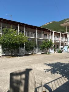 a chair in front of a large building at Sunset Panorama Residence in Vlorë