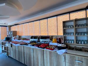 a kitchen with a buffet line with food at Real Hotel Van in Ipekyolu