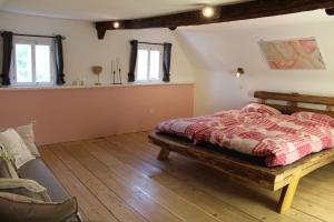 a bedroom with a bed and a couch at Ferienhaus Elsa mit Sauna und Whirlpool in Großschönau