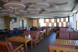 a dining room with tables and chairs and a ceiling at Real Hotel Van in Ipekyolu +13 photos