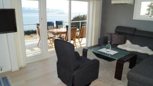 a living room with a couch and a table at Kvalheim Nordfjord in Myre