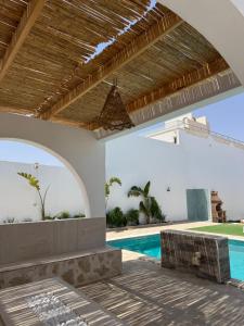 an external view of a house with a swimming pool at Villa Mazzyd in Temlale