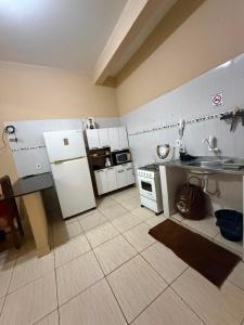 a small kitchen with white appliances in a room at APT da Orla 305 in Santarém +10 photos
