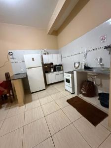 a kitchen with a white refrigerator and a sink at APT da Orla 305 in Santarém